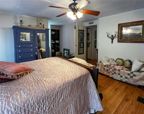 a bedroom with a bed and dresser with mirror