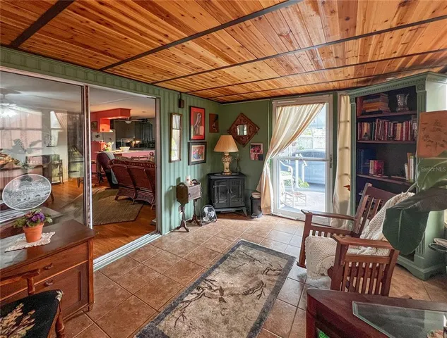 a living room with furniture a fireplace and a floor to ceiling window