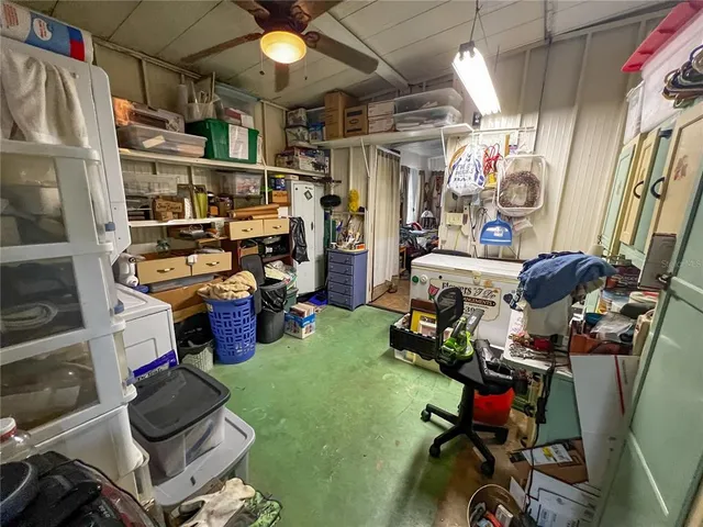 a room with gym equipment and wooden floor
