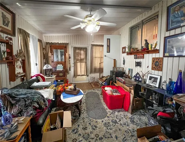 a living room with furniture a rug and a chandelier