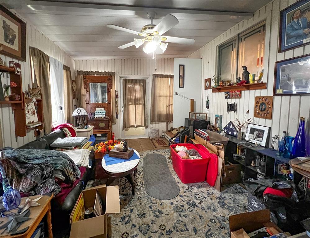 34543 Rosebud Row Zephyrhills, FL 33541 - Photo 25 of 41 a living room with furniture a rug and a chandelier