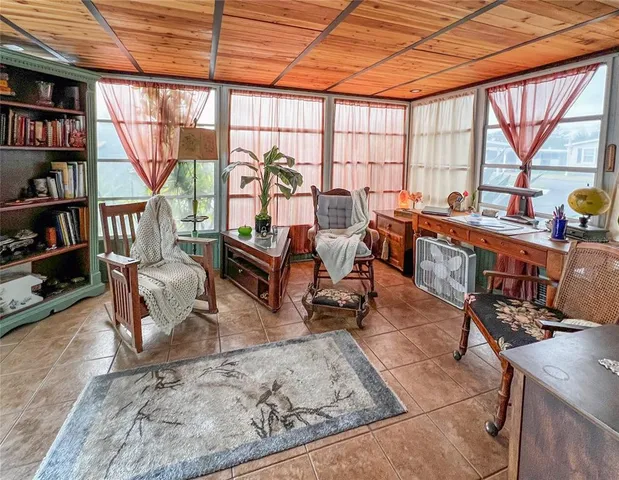 a living room with furniture a rug and a large window