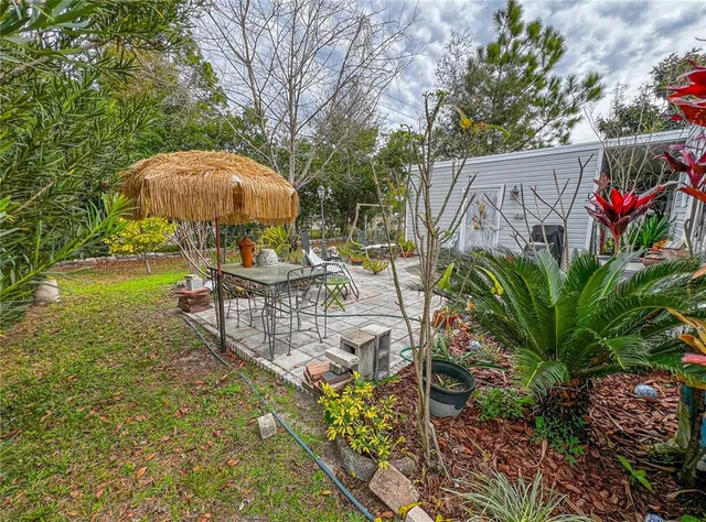 a view of a backyard with a patio and plants