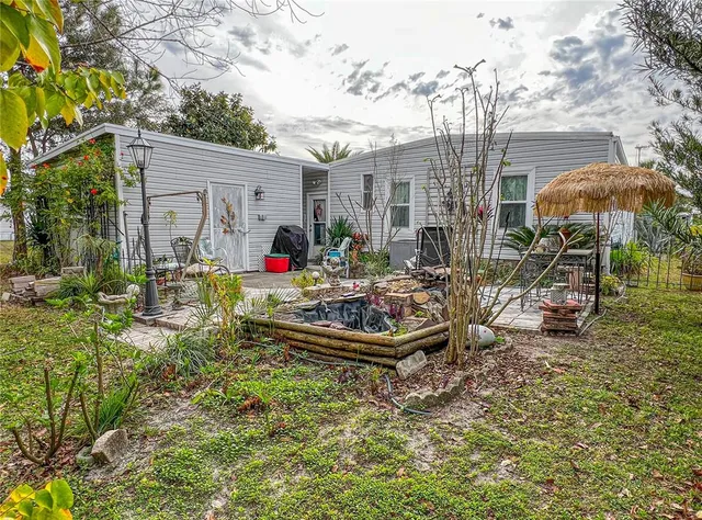 a front view of house with yard outdoor seating and barbeque oven