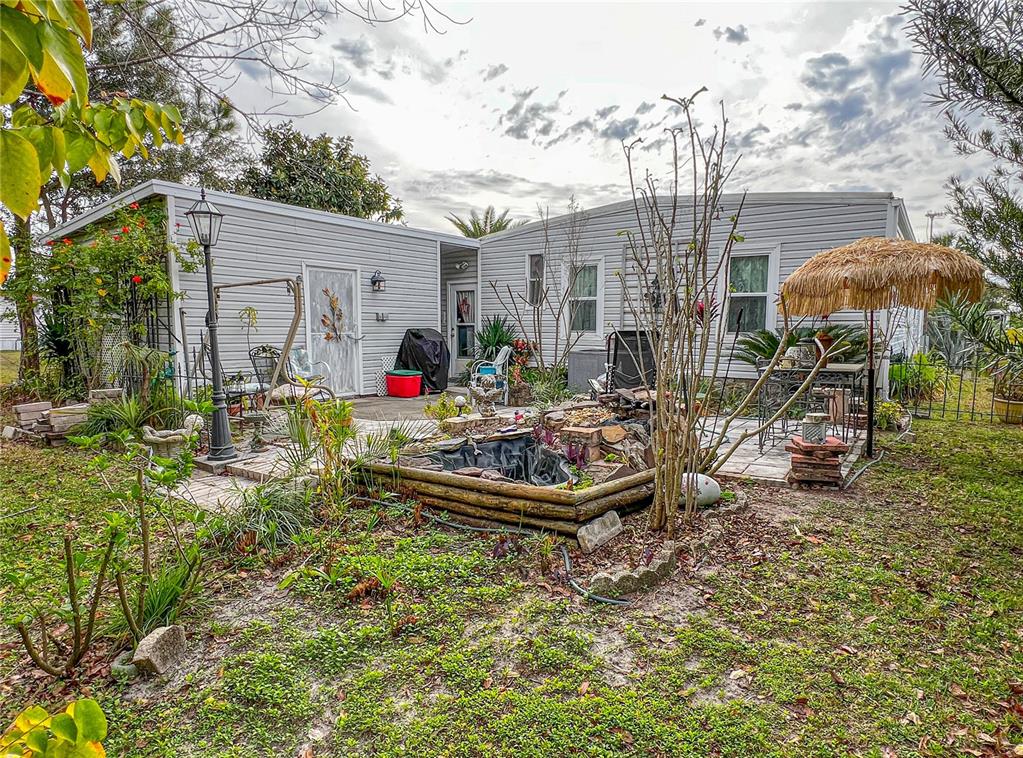 34543 Rosebud Row Zephyrhills, FL 33541 - Photo 34 of 41 a front view of house with yard outdoor seating and barbeque oven