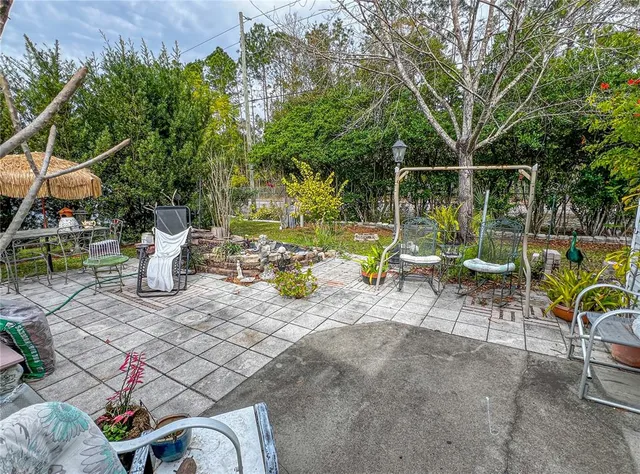 a view of a chairs and table in backyard