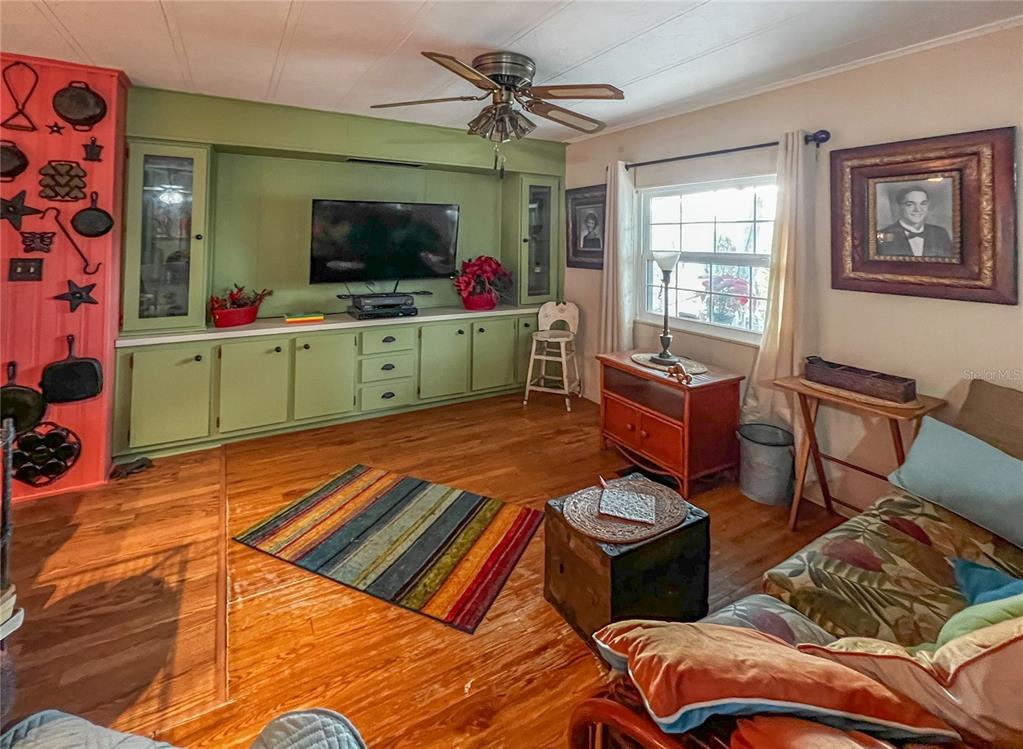 34543 Rosebud Row Zephyrhills, FL 33541 - Photo 6 of 41 a living room with furniture and a flat screen tv