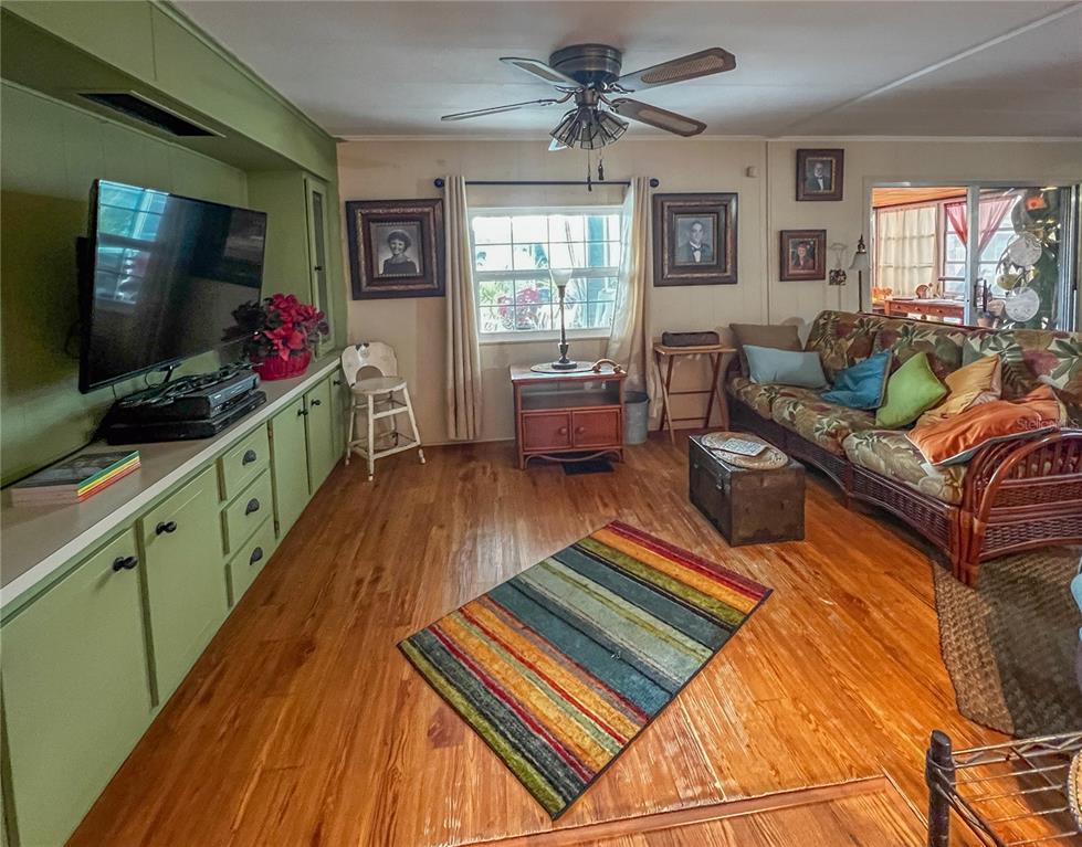 34543 Rosebud Row Zephyrhills, FL 33541 - Photo 7 of 41 a living room with furniture and a flat screen tv