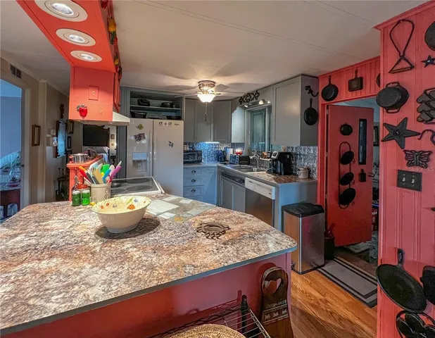 a kitchen with a sink and a stove top oven