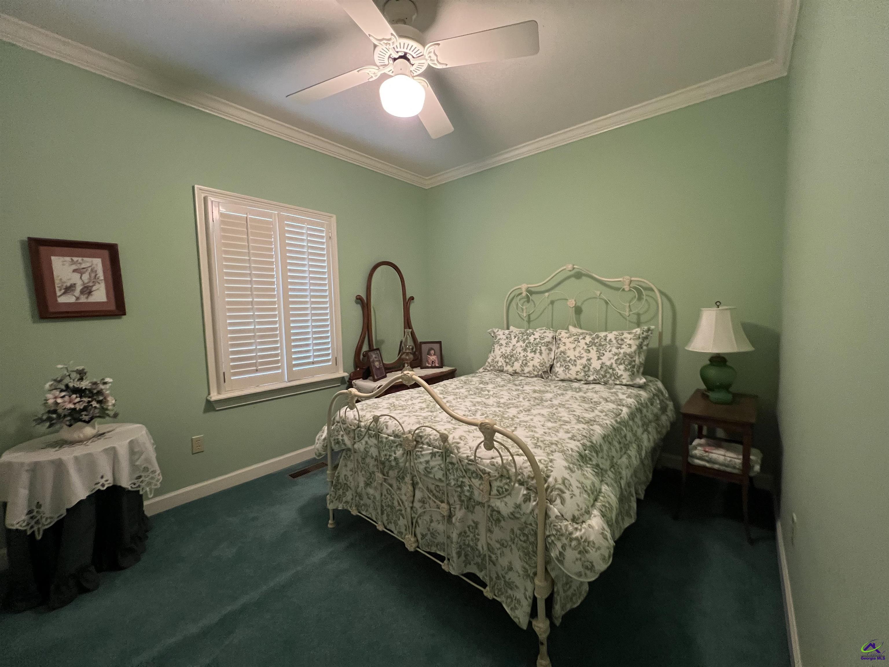 762 Nicholson-Carr Road Chester, GA 31012 - Photo 21 of 81 a bedroom with a bed and a chandelier