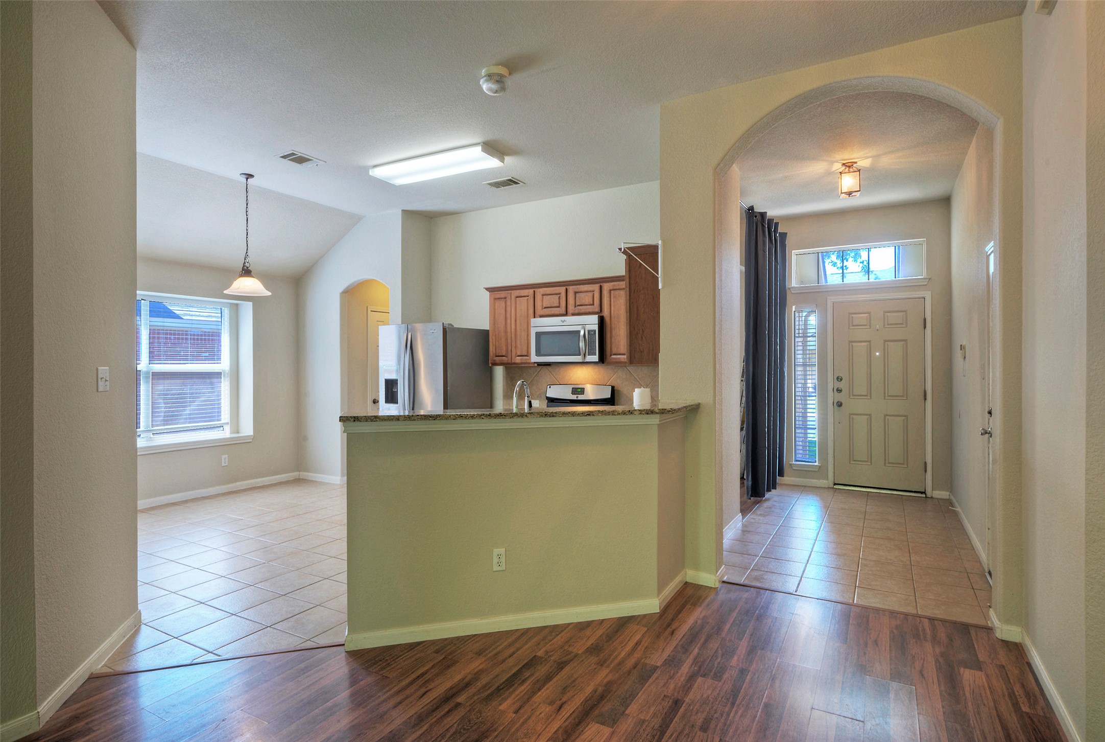 400 Pheasant Ridge Drive Round Rock, TX 78665 - Photo 13 of 29 Kitchen featuring wooden cabinetry, stainless steel appliances, and a breakfast bar