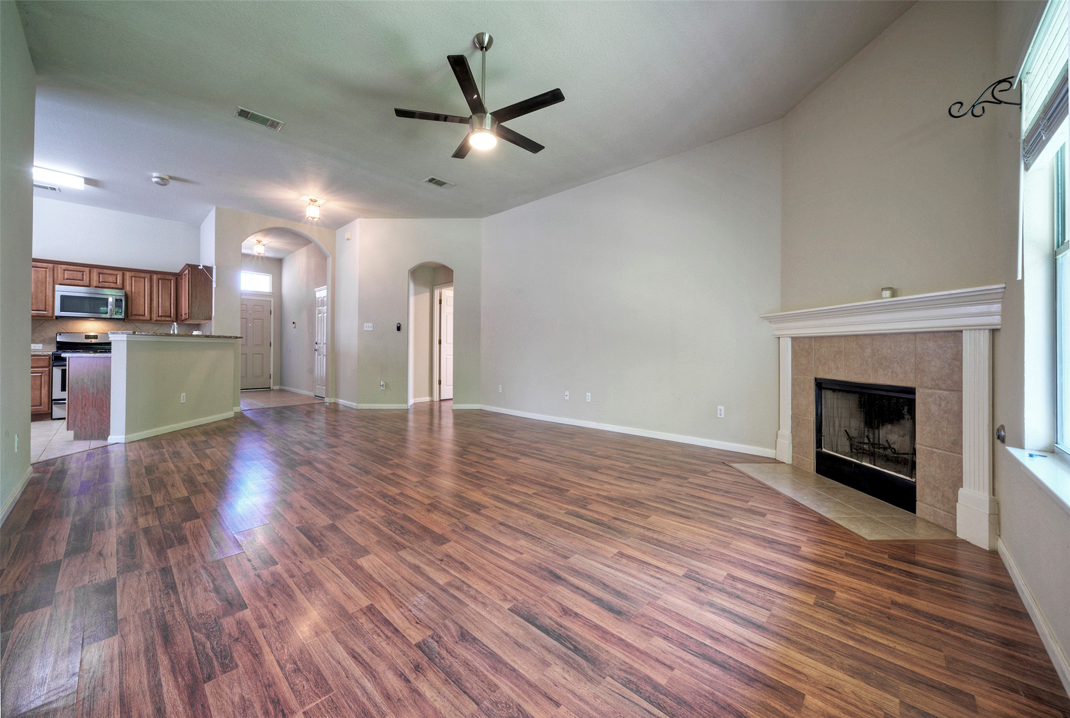 400 Pheasant Ridge Drive Round Rock, TX 78665 - Photo 15 of 29 Spacious main living area featuring wood-finish flooring, a ceiling fan, and vaulted ceilings