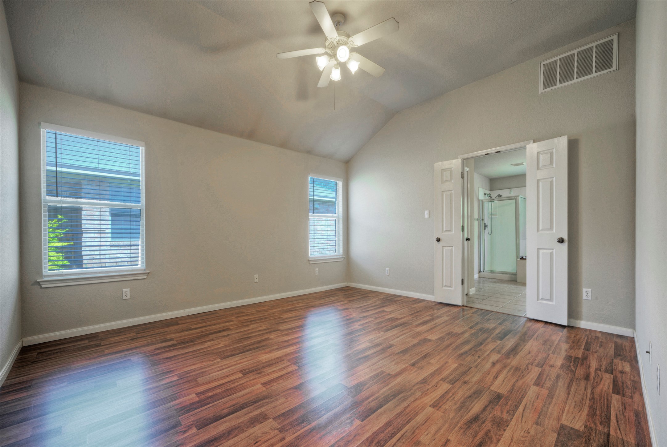 400 Pheasant Ridge Drive Round Rock, TX 78665 - Photo 24 of 29 Spacious room featuring wood-finish flooring, a vaulted ceiling, and two windows with blinds
