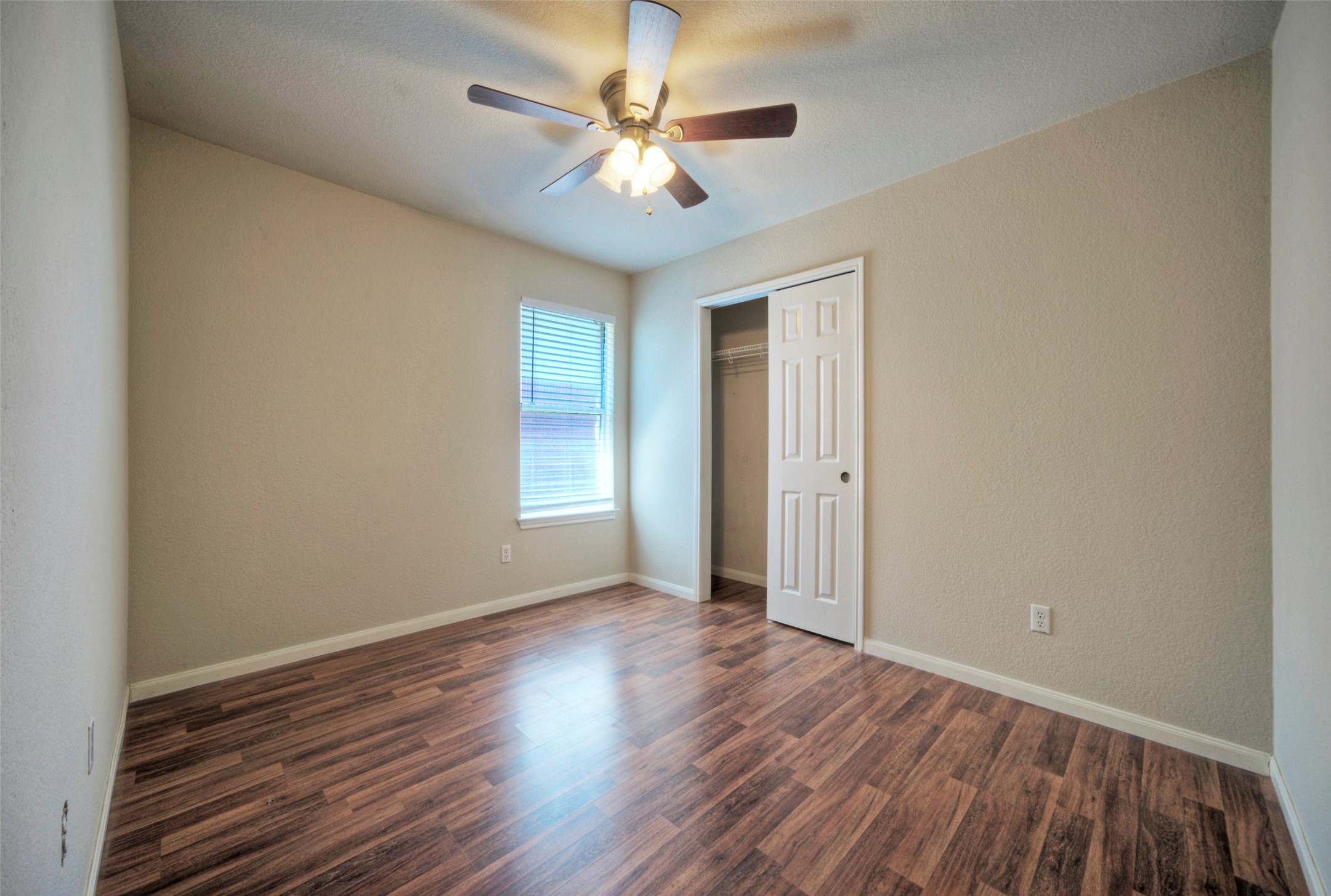 400 Pheasant Ridge Drive Round Rock, TX 78665 - Photo 27 of 29 Room featuring wood-finish flooring, a ceiling fan with integrated lighting, and neutral wall paint