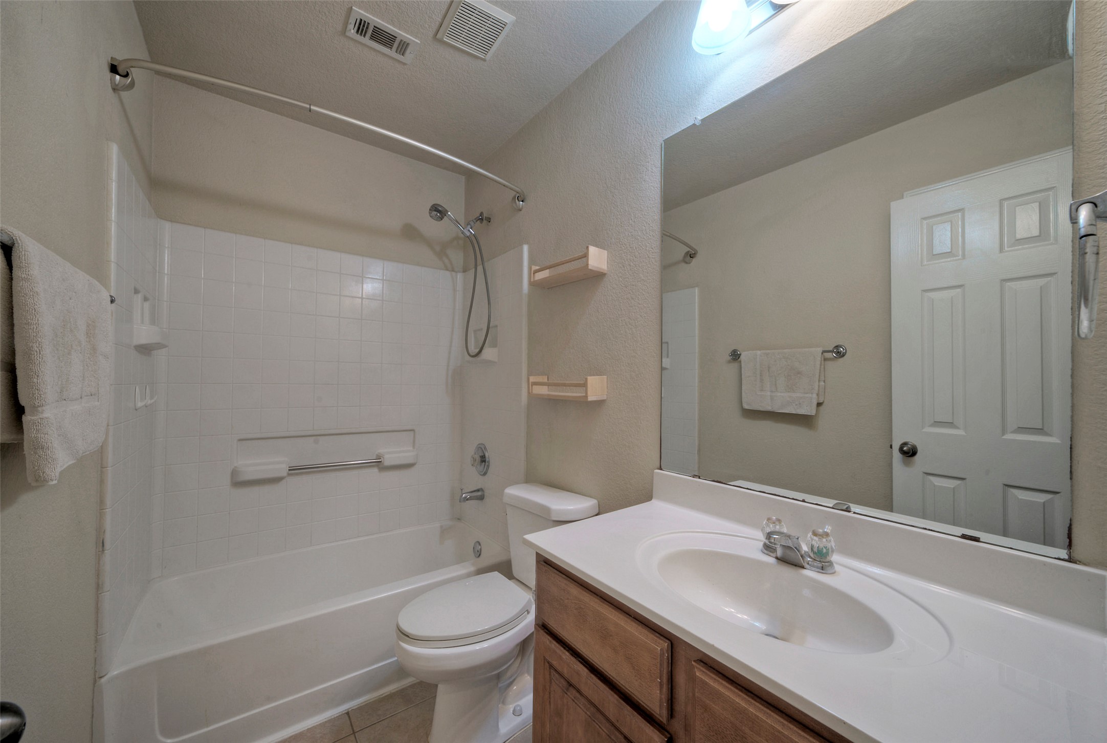 400 Pheasant Ridge Drive Round Rock, TX 78665 - Photo 29 of 29 Full bathroom featuring a single vanity with wood-finish cabinetry, a white countertop, and an integrated sink