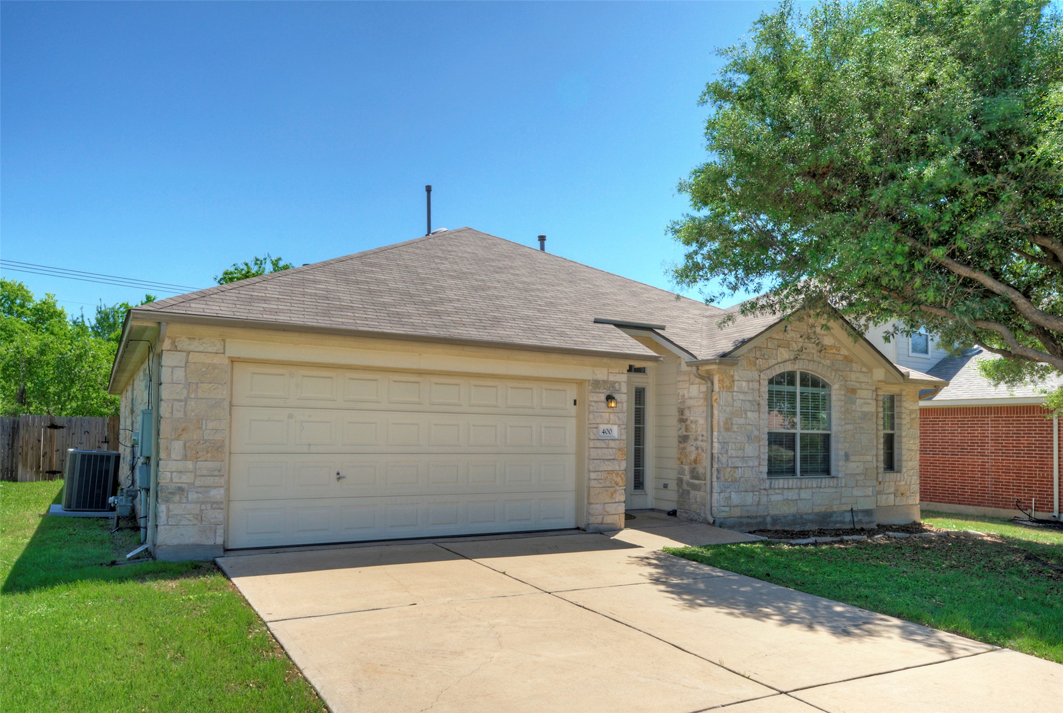 400 Pheasant Ridge Drive Round Rock, TX 78665 - Photo 3 of 29 Stone facade with a two-car garage and arched window detail