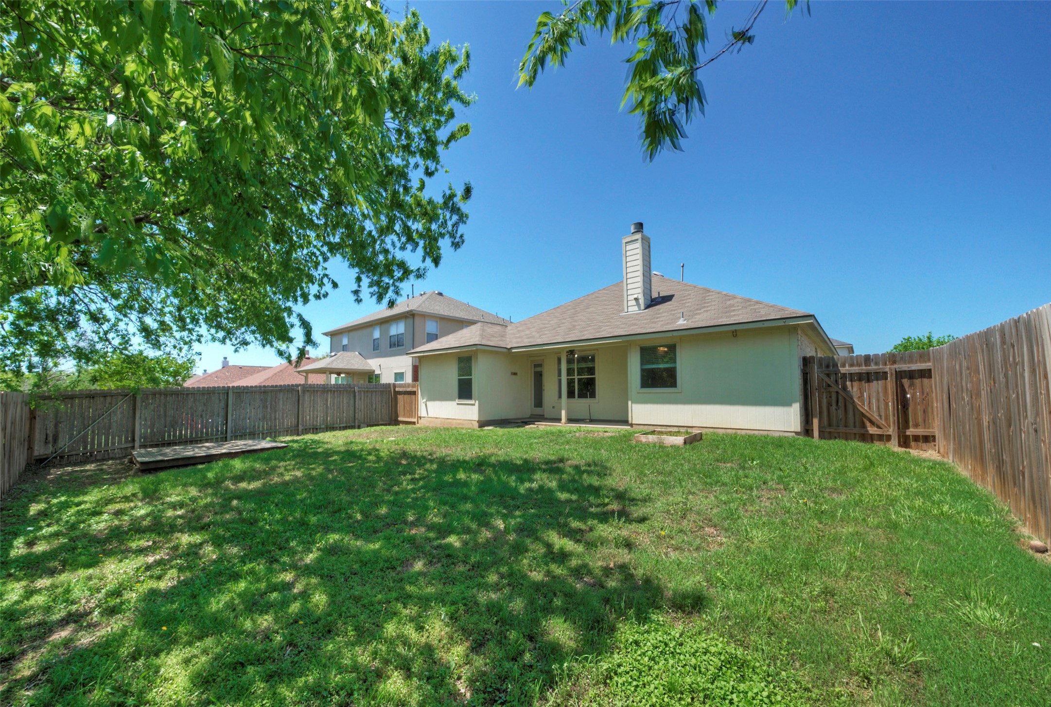 400 Pheasant Ridge Drive Round Rock, TX 78665 - Photo 5 of 29 Expansive fenced backyard with a grassy lawn and mature trees providing natural shade
