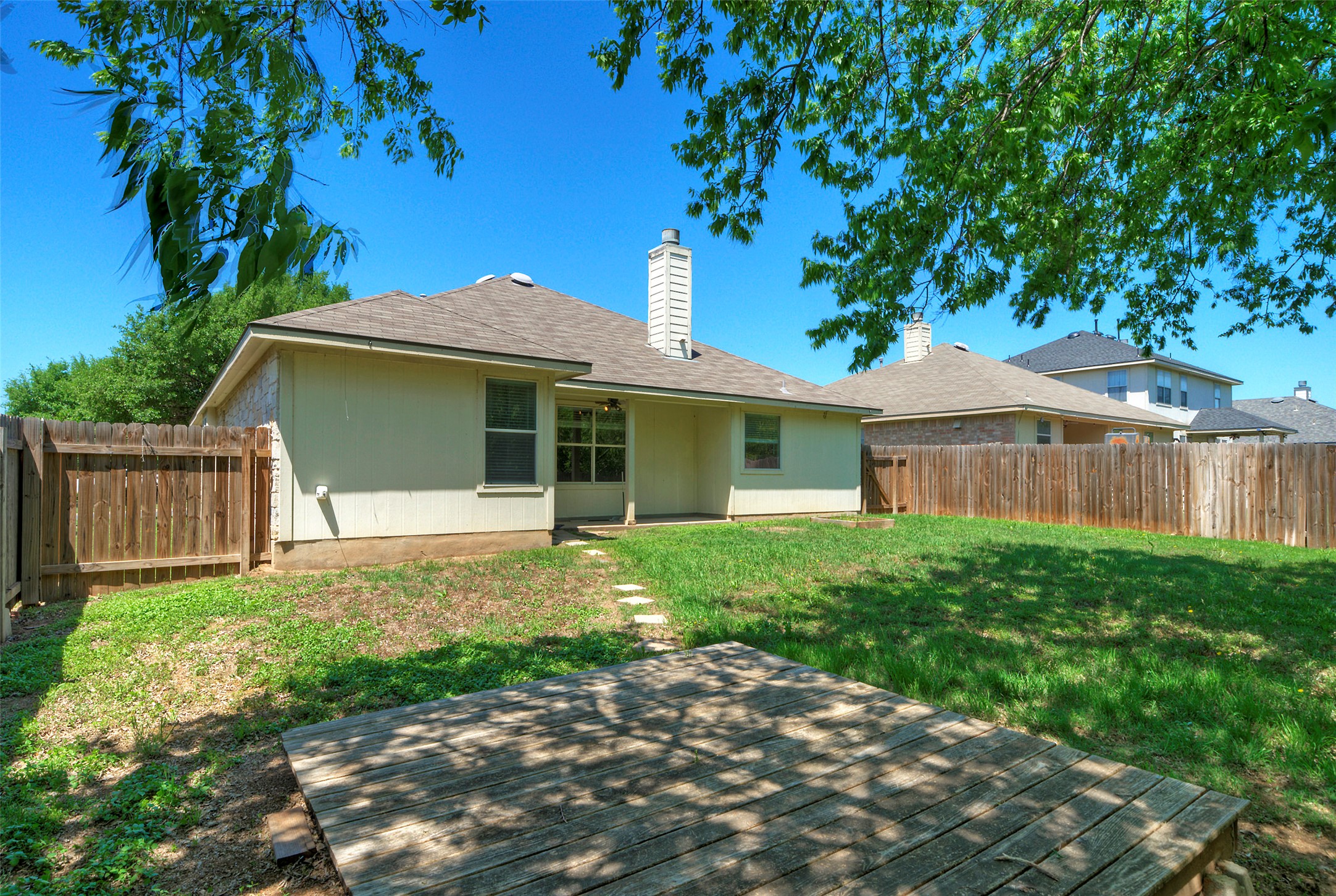 400 Pheasant Ridge Drive Round Rock, TX 78665 - Photo 6 of 29 Expansive rear yard featuring a wooden deck, natural grass, and a wood privacy fence