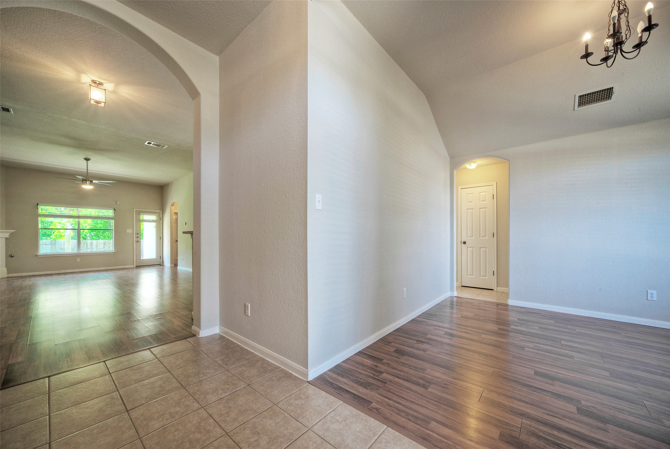 400 Pheasant Ridge Drive Round Rock, TX 78665 - Photo 8 of 29 Arched entryway leading to an open living area with wood-finish flooring and a ceiling fan