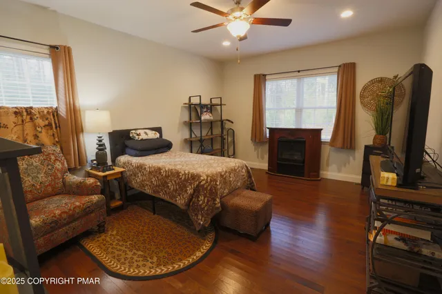 a bedroom with a bed a couch and dresser