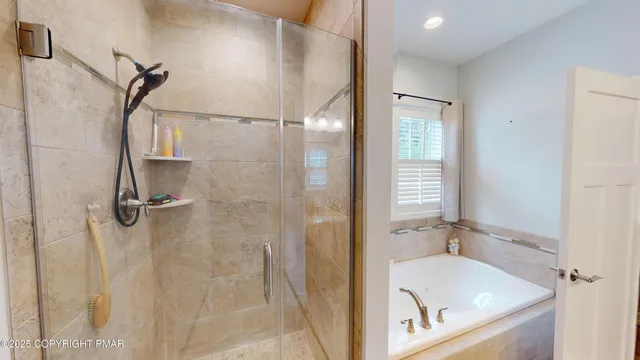 a bathroom with a tub and a shower