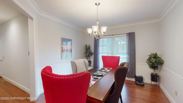 a living room with furniture flowers and a chandelier