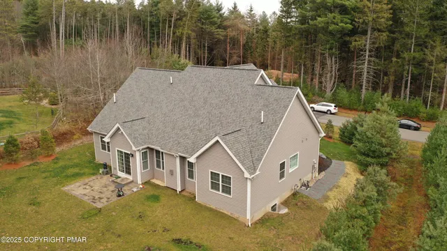 a aerial view of a house with a yard