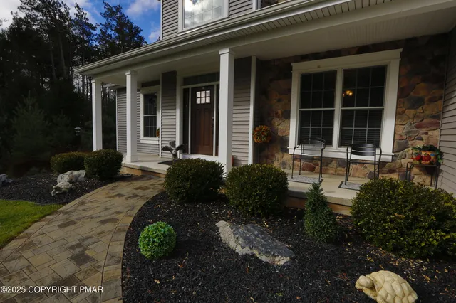 a front view of a house with garden