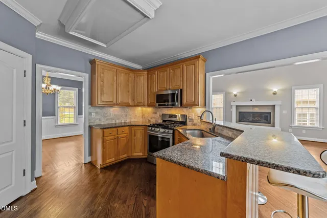 a kitchen with granite countertop stainless steel appliances and wooden cabinets