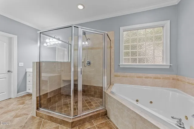 a bathroom with a tub shower and mirror