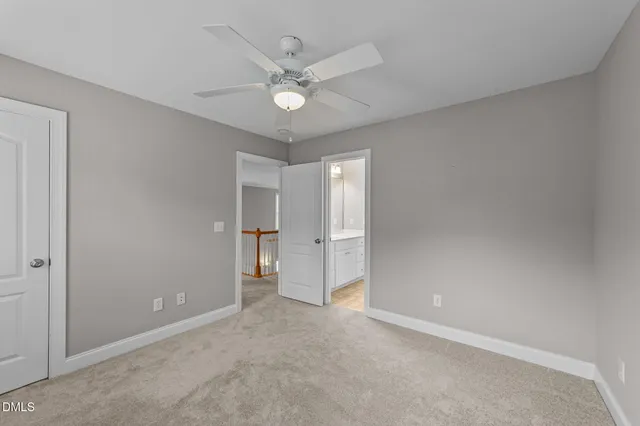 a view of an empty room with a ceiling fan