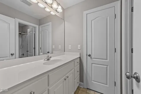 a bathroom with a sink vanity and a mirror