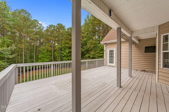 a balcony with wooden floor and fence