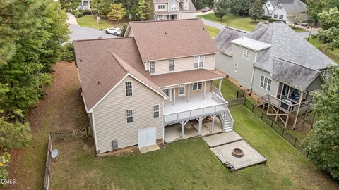 an aerial view of a house with a yard