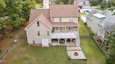 an aerial view of a house with a yard