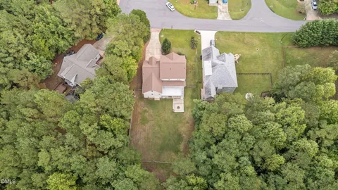 an aerial view of a house with outdoor space and a lake view