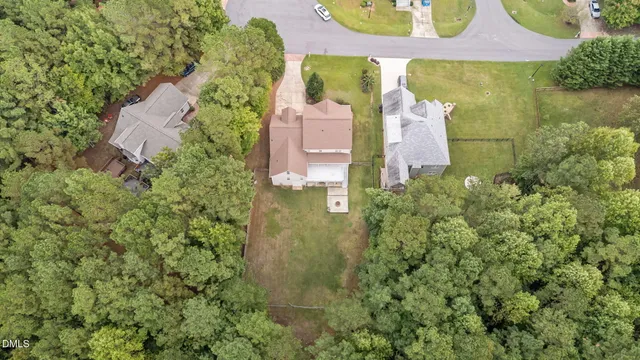 an aerial view of a house with outdoor space and a lake view