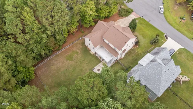 an aerial view of a house with outdoor space and a lake view