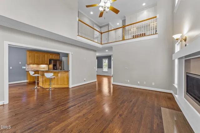 a view of a livingroom with wooden floor and a fireplace