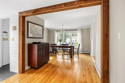 a dining room with furniture and wooden floor