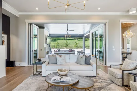 a kitchen with stainless steel appliances a sink stove and wooden floor
