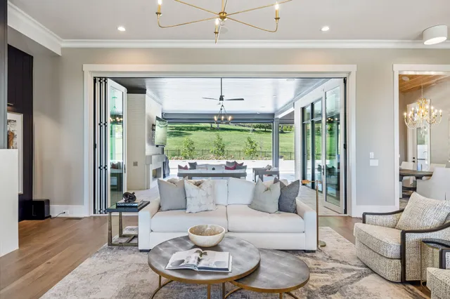 a kitchen with stainless steel appliances a sink stove and wooden floor