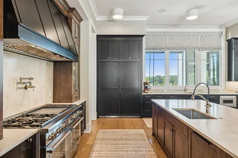a bedroom with a large bed and a chandelier