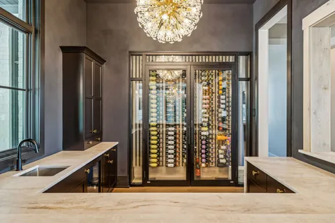 a large white bathroom with a double vanity sink a mirror and a bathtub