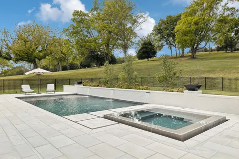 a view of a house with wooden fence