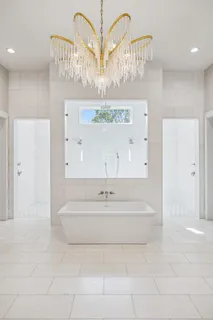 a bedroom with a large bed and a large window