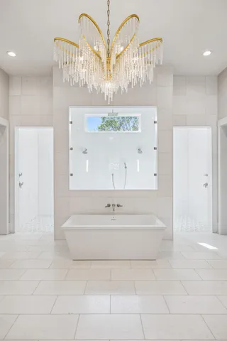 a bedroom with a large bed and a large window