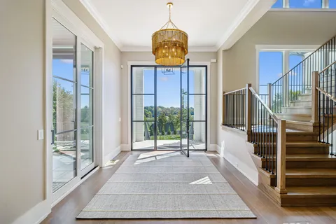 a living room with fireplace furniture and a large window