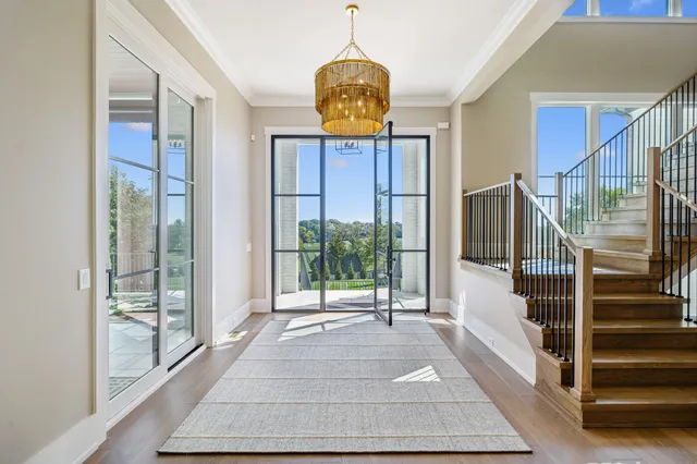 a living room with fireplace furniture and a large window