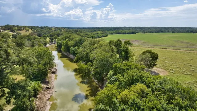a view of a lake with houses in the back